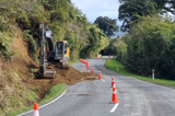 A bulldozer working on the side of a road