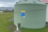Water storage tank installed on a green field