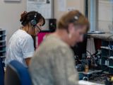 Two women at a customer service center on the phone