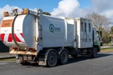 Rubbish truck collecting waste and recycling