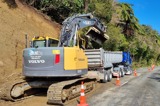 Excavator working on road