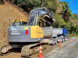 Excavator working on road