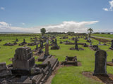 Graves at a cemetery in the sunshine