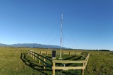 The automated weather station mast located on farmland at Westport Airport